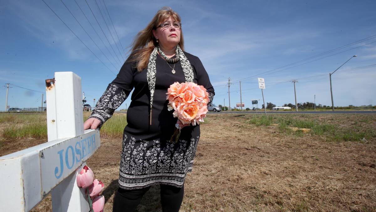 RELIEF: Rosanne Bianchini stands by a memorial to her son Joseph near the intersection where he was killed. Picture: Anthony Stipo.