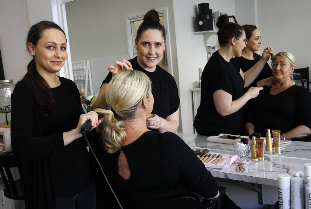 PAMPERED: Lauren Kennedy and Dimity Heffernan from the Style Bar work their magic with Anabel Williams from the business chamber for the Crow Awards. Picture: Les Smith.
