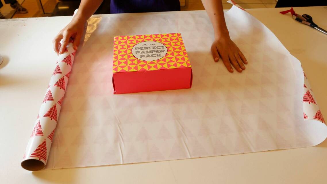 Vision Australia volunteer Rosalyn D'Angelo demonstrates the step-by-step wrapping process.