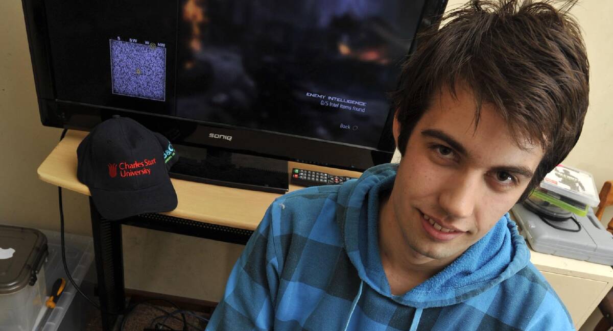PLAYING WITH FIRE: Joshua Graham, a gamer and software developer from Uranquinty, doesn't think games should have 'in-game purchases'. Picture: Les Smith.
