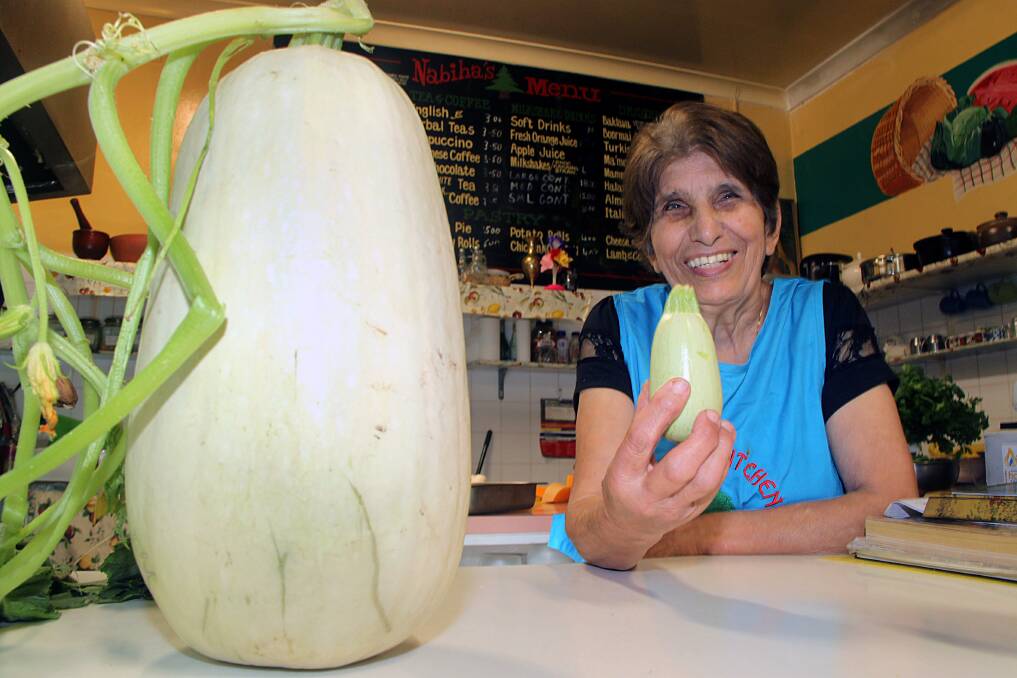 HUGE: Wagga cafe owner Nabiha Koriaty with one of the giant zucchinis she grew in the garden. Mrs Koriaty says growing fresh vegetables has kept her fit and healthy.