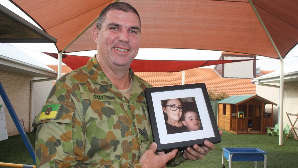 Sgt Beau Cox holds a photo of his family, who were greatly supported by Kurrajong Therapy Plus.