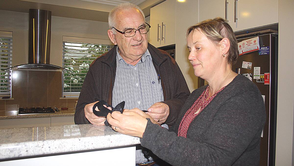 HELP: Palliative care nurse practitioner Jenny McKenzie shows Bill Robinson some equipment for his wife Pam, who has motor neurone disease. The unsung heroes of health help people live their last days to the full.
