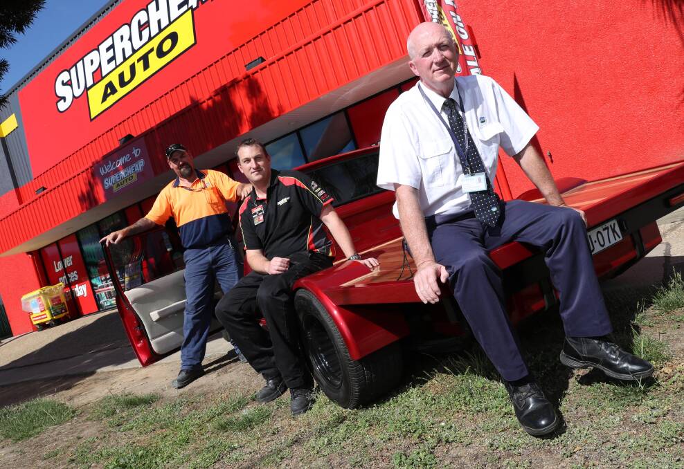 HOLDEN OUT FOR 60K: Peter Holt, industries manager, Jason Bortolazzo, manager of Supercheap and Trevor Coles, offender services manager. Picture: Les Smith