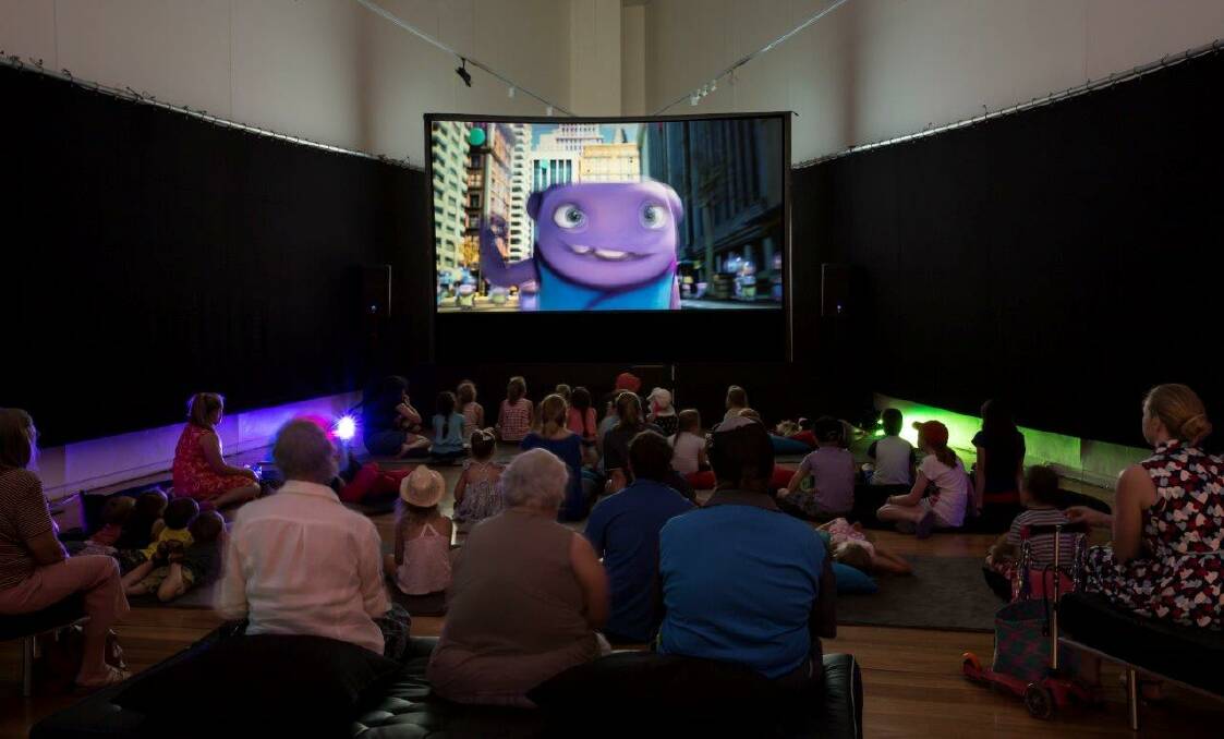 SILVER SCREEN: Little and big kids soaking up the gallery's massive Dolby digital surround sound set up. Picture: Contributed.