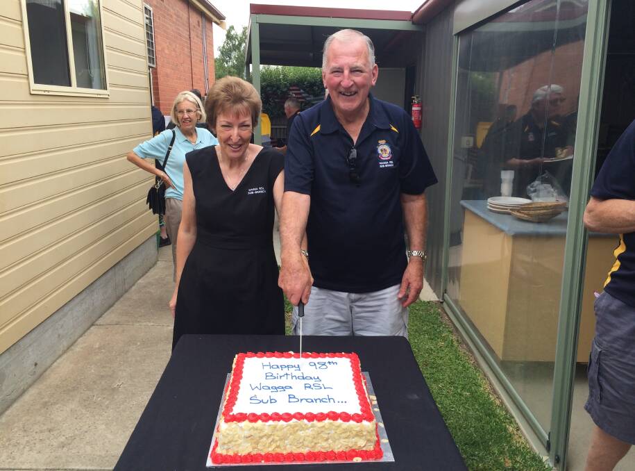 HAPPY BIRTHDAY: Tanya Barker and David Gardiner cut the cake made to celebrate the Wagga RSL sub-branch's 98th birthday. Picture: Ken Grimson