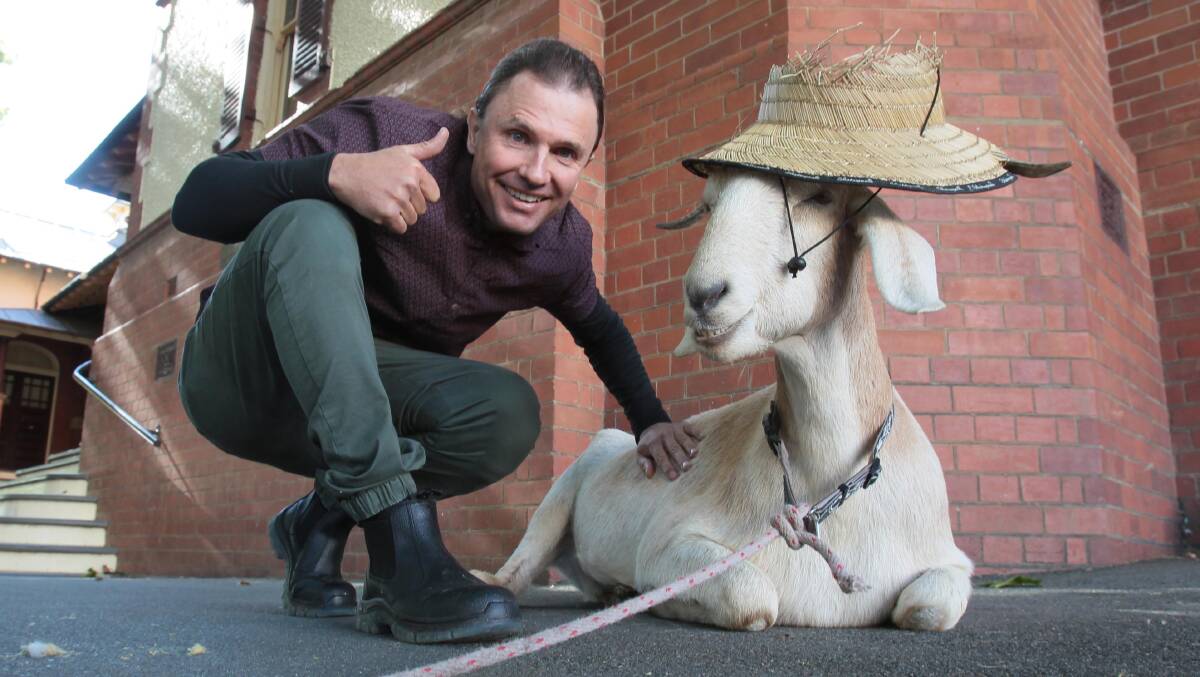 Gary the goat is all smiles as Jimbo gives the thumbs up before going into court: Picture: Les Smith