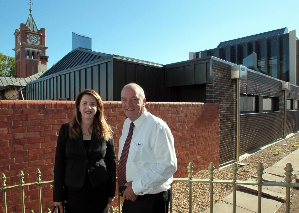 EXCITED: Maggie Orman and Daryl Maguire stand in Fitzmaurice Street outside Wagga's new court facilities behind. Picture: Les Smith