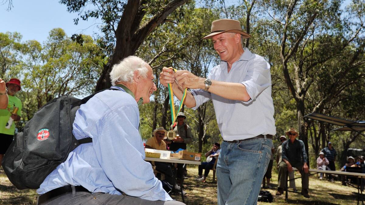 RAIL TRAIL SUPPORT: Tumbarumba mayor Ian Chaffey receives a medal from member for Riverina Michael McCormack after completing the Tumba Trek bushwalk.