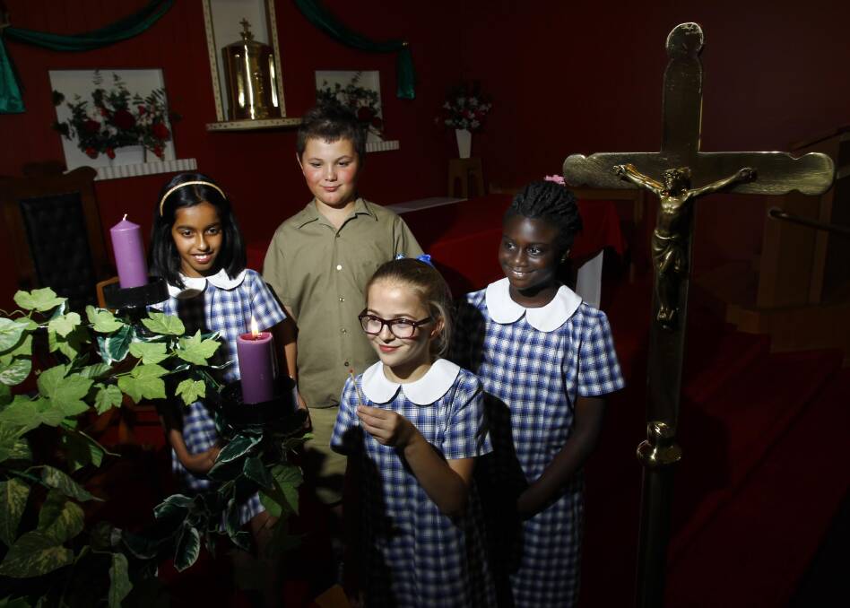 ADVENT: With the Advent wreath in Our Lady of Fatima Catholic Church are Henschke Primary School pupils Noyelmaria Rajeev, Max Warr, Abbey Hartley and Alina Osei. Picture: Les Smith