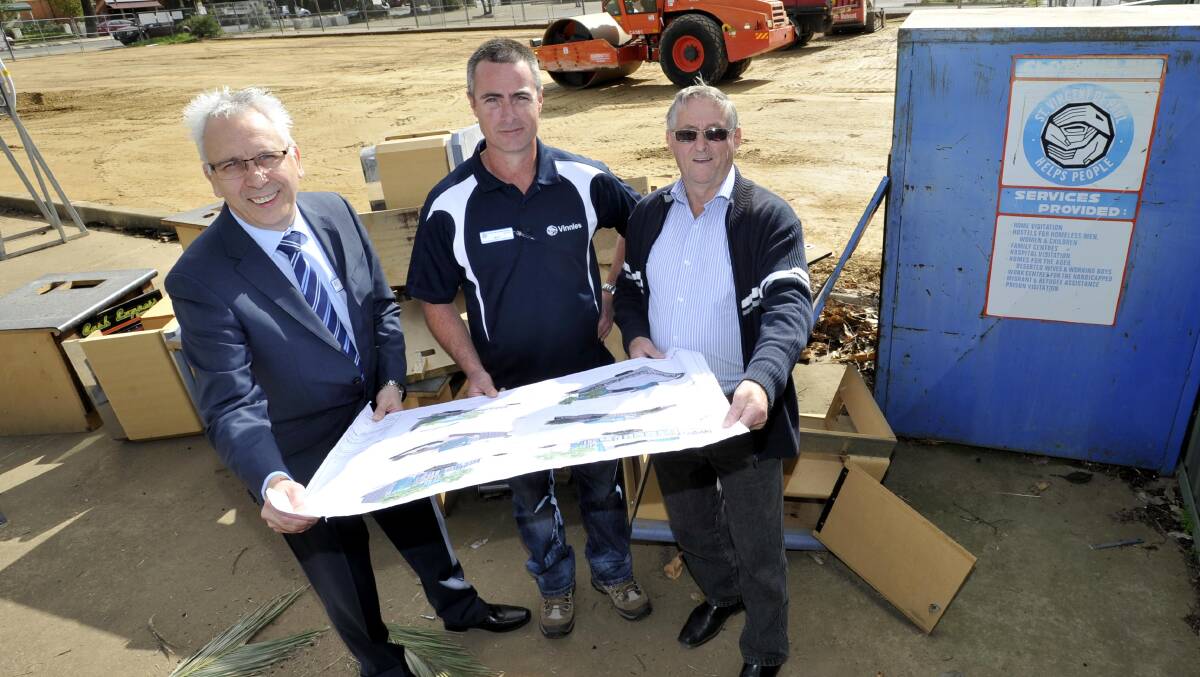 BIGGER AND BETTER: With a plan of the new Vinnies building as earthworks continue behind them on the new site are, from left: Mike Riley, Matt Kanck and Don Jones. Picture: Les Smith