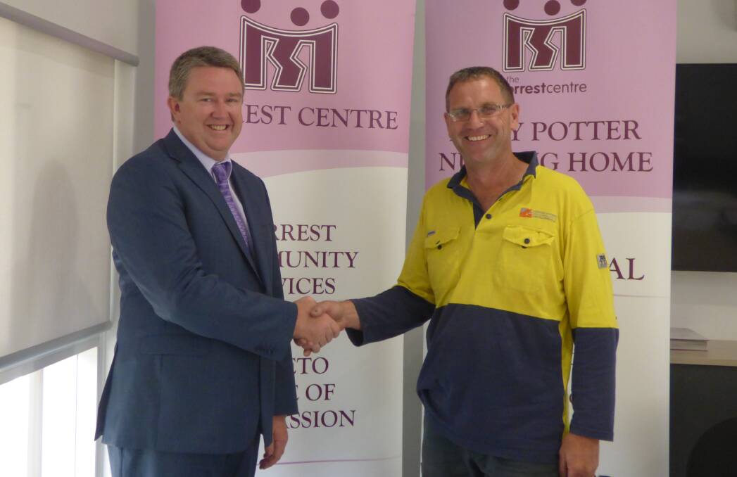 MILESTONE: Forrest Centre chief executive officer Evan Robertson and builder Stephen Lawrence shake hands after signing the palliative care hospice construction contract.