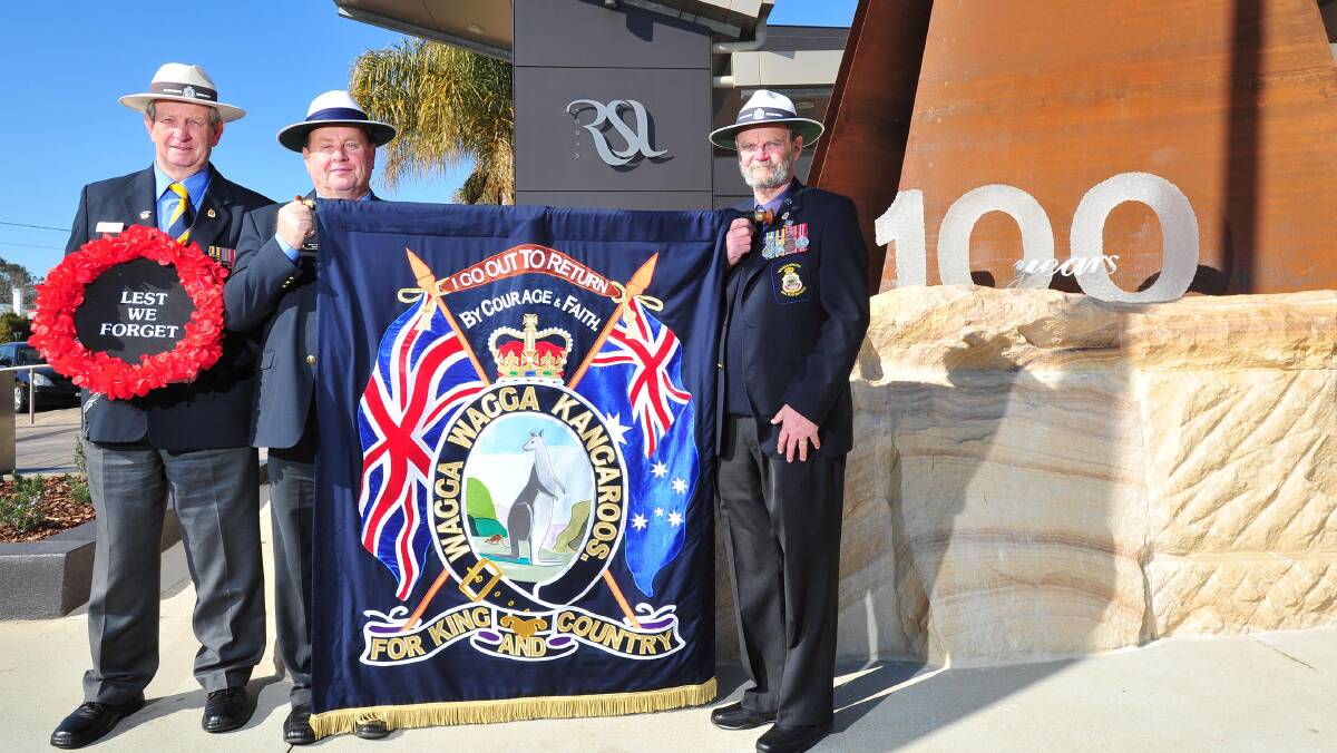 ALMOST READY: With the Kangaroo March re-enactment march banner based on the original are, from left: Wagga RSL sub-branch president Kevin Kerr, treasurer Brian Watts and secretary Ken May. Picture: Kieren L Tilly