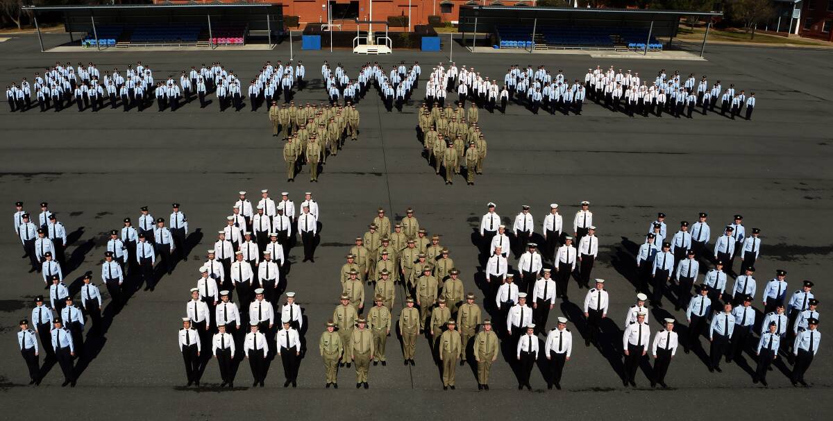 HISTORIC: Air force, army and navy personnel at RAAF Base Wagga form up to display RAAF Wagga 75 years. RAAF photographer, Sergeant Bill Guthrie, snapped the image 25 years on from the image he organised for the base's 50th.