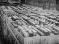 Used beer bottles packed in wooden banana boxes at Wagga rail yards ready to sent for recycling. Picture supplied (CSURA Lennon Collection.