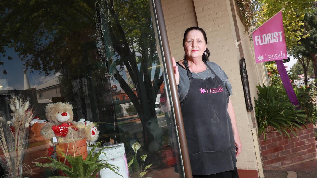 CONFUSION: Lilly of the Valley owner Narelle Wilson says her shop's flag is not hurting anybody. Picture: Les Smith