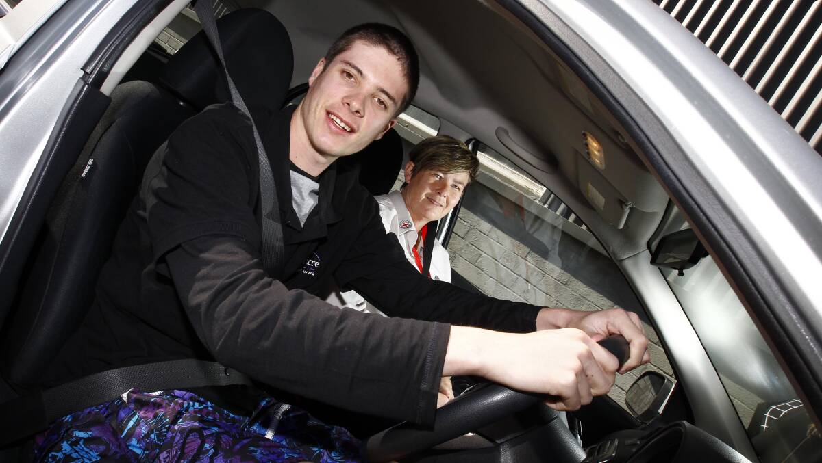 STEERING FUTURES: Driving lesson participant Jake Lynch with Red Cross community programs officer Jennifer Cameron. Picture: Les Smith 