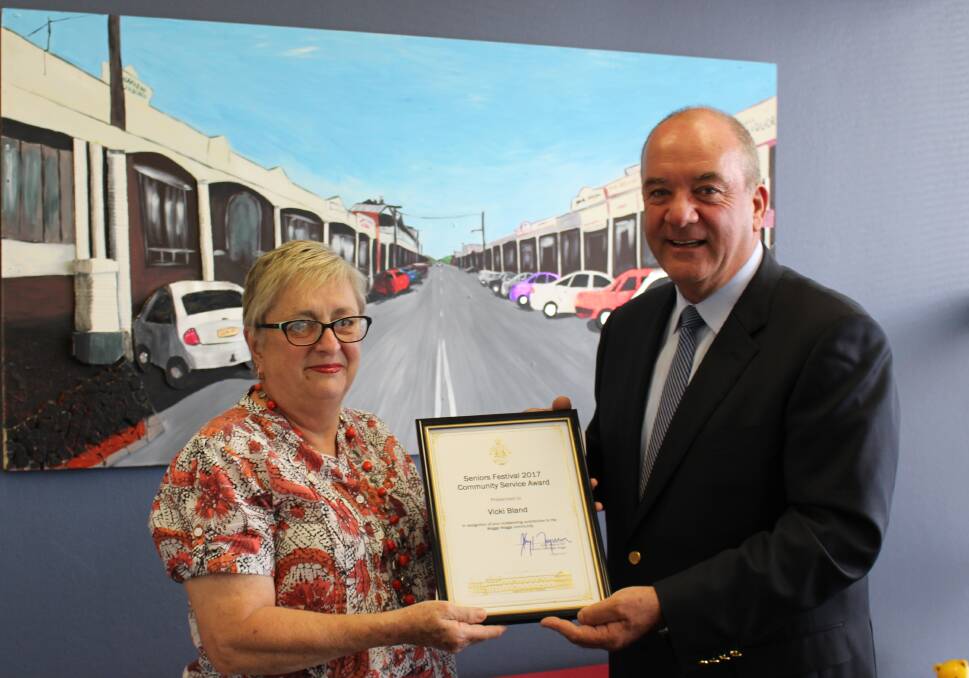 AWARD: Vicki Bland being awarded for her various community efforts in caring for the elderly, presented by Wagga MP Daryl Maguire. 