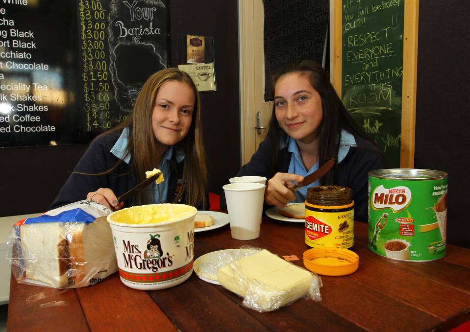 HEALTHY HABITS: Year 8 students Imogen O'Mahoney and Calais Bennett, both 14, enjoying Wagga High School's breakfast club. Picture: LES SMITH  