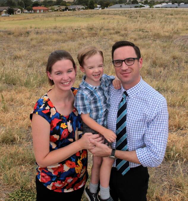 GROWTH: Oliver Cotter, 3, with his parents Christina and Graham at the site where land was earmarked for a future Estella school in 2016. 
