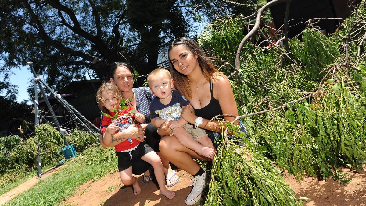 CLOSE CALL: Jessica Berg beside the collapsed tree with her children Kotari (3), Djkiri (1) and Uriah (16).