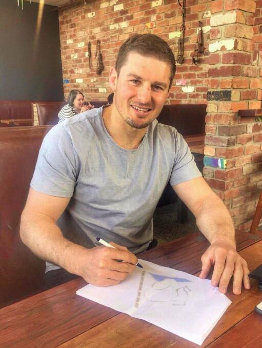PEN TO PAPER: Social media posts revealed Buttriss was in town last week to meet with local players and discuss plans for next season. Picture: Facebook