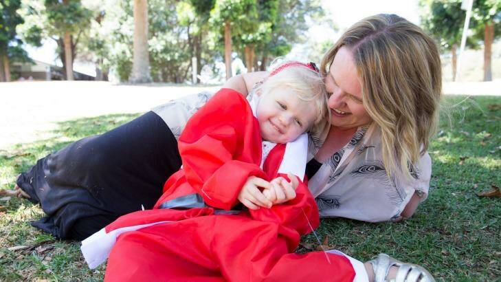 Natalie and Lila Dillenbeck who will turn 3 this month, promoting the Santa Fun Run, in Centennial Park.  Photo: Janie Barrett