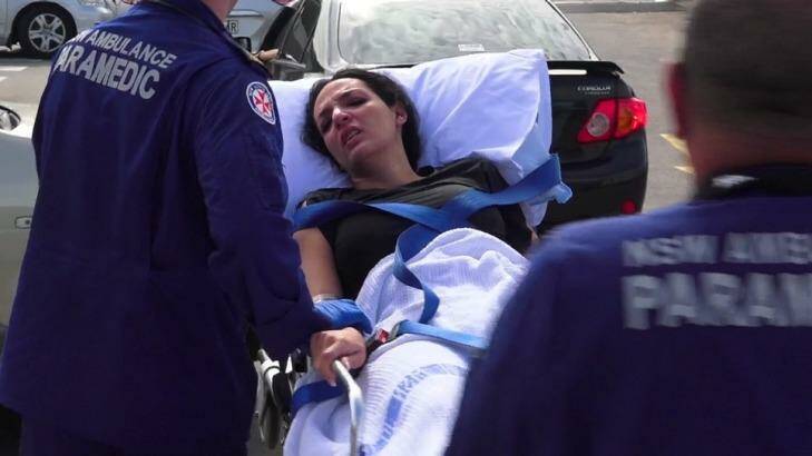 Hoda Darwiche is wheeled away by paramedics after the shooting at Bankstown Central Shopping Centre. Photo: Top Notch Video 