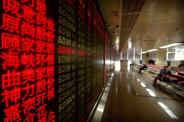 Chinese investors monitor stock prices at a brokerage house in Beijing, Tuesday, Nov. 7, 2017. Asian stocks surged Tuesday after Wall Street posted modest gains on deal reports and turmoil in Saudi Arabia sent crude prices soaring. (AP Photo/Mark Schiefelbein)
