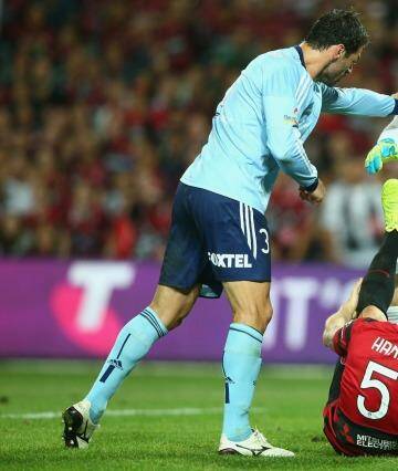 Helping hand: Vedran Janjetovic reaches out to Brendan Hamill during the Sydney derby. Photo: Getty Images 