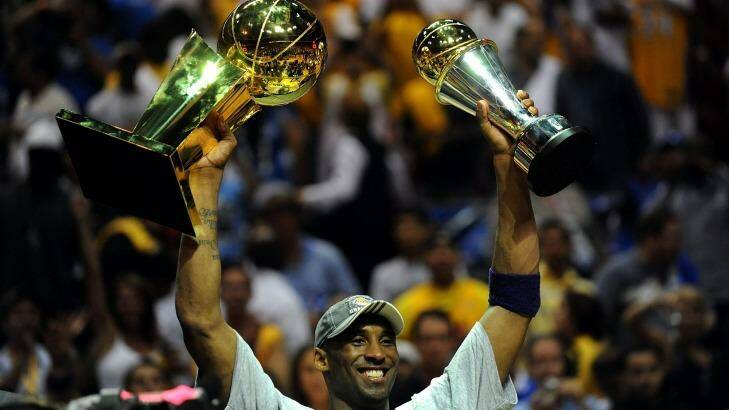 Star: Kobe Bryant holds up the Larry O'Brien trophy and the Bill Russell MVP trophy after the Lakers defeated the Orlando Magic 99-86 in Game Five of the 2009 NBA Finals. Photo: Ronald Martinez