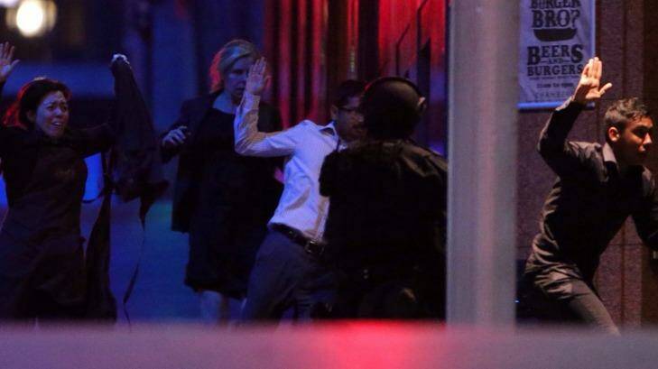 The group of hostages fleeing the cafe just before 2am.  Photo: Andrew Meares