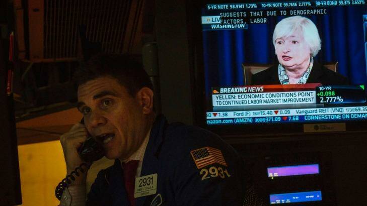 A trader at the New York Stock Exchange makes a call last year as Federal Reserve boss Janet Yellen talks about the economy. Photo: Brendan McDermid