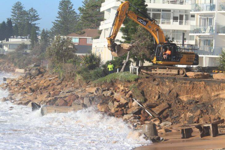 SMH News. Day 5 of Sydney storms. Massive boulders lifted into place. The Scene at Collaroy Beach this morning after laying some 12,000 sand bags overnight. Photo Peter Rae WEDNESDAY June 8TH 2016