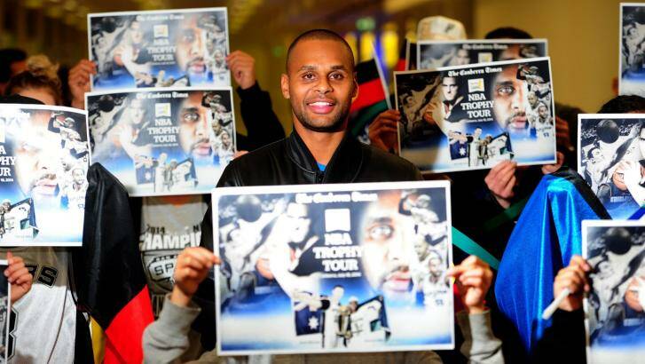Patty Mills with the limited edition <i>The Canberra Times</i> posters, which will be available at Friday's Civic reception. Photo: Melissa Adams