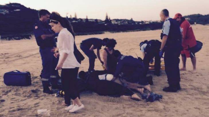 Bodyboarder Dale Carr being treated at the scene after a shark attack at Port Macquarie. Photo: Supplied