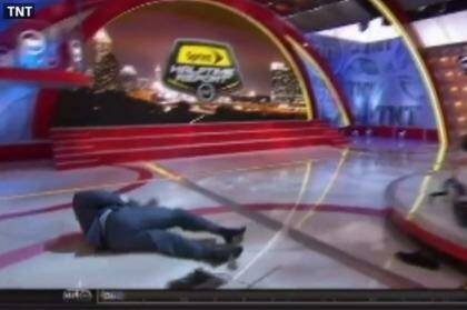 Man down: Shaq hits the canvas after becoming tangled in cables.