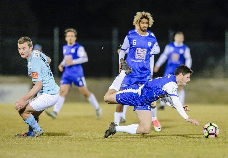 Belconnen United v Canberra Olympic. Belconnen United's Sam Smith challenges Olympic's Tim Bobolas. Photo: Sitthixay Ditthavong