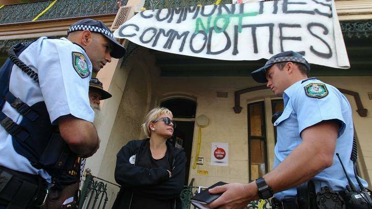 "A farce": Tayce, 27, speaks with police in Millers Point.  Photo: Ben Rushton/Getty Images