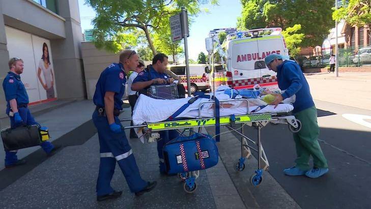 Paramedics take Amy Rickuss from The Cosmetic Institute to Westmead Hospital on Friday.  Photo:  Webcam-NT
