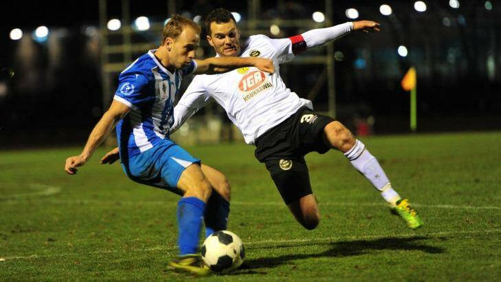 Right, Dustin Wells of Gungahlin United FC attempts to tackle Brayden Sorge of Sydney Olympic FC. Photo: Melissa Adams