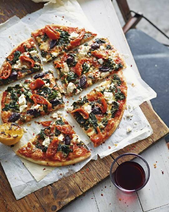 Pete Evans's pizza with fetta, semi-dried tomatoes and olives <a href="http://www.goodfood.com.au/good-food/cook/recipe/pizza-with-spinach-with-fetta-semidried-tomatoes-and-olives-20120627-29tws.html"><b>(recipe here).</b></a> Photo: Supplied