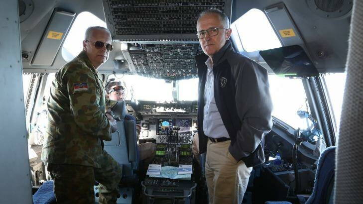 Chief of the Defence Force Air Chief Marshal Mark Binskin and Prime Minister Malcolm Turnbull in discussion on the flight deck of a C-17 Globemaster during their flight to Iraq. Photo: Alex Ellinghausen