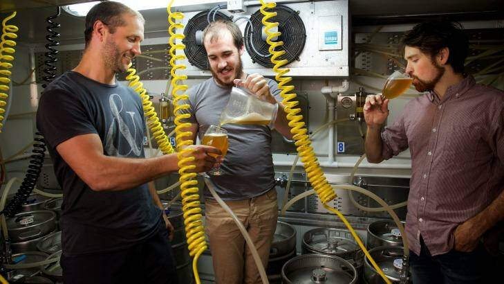 Fizzing: Scientists and amateur beer brewers Scott Brownless, centre, and Chad Husko, right, sample one of their creations with Alex Judge. Photo: Wolter Peeters