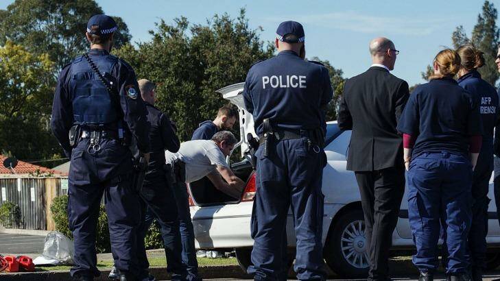 Police conduct a search during the counter-terrorism raids in September. Photo: Christopher Pearce