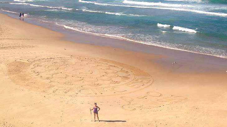 Port Macquarie artist Chloe Dickey reveals the ship names in a sand mural at Sydney's Bondi Beach.