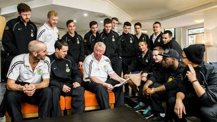 Tuggeranong United players talk strategy with coach Steve Forshaw in the lobby of the Alpha Hotel ahead of their match against Melbourne Victory. Photo: Rohan Thomson