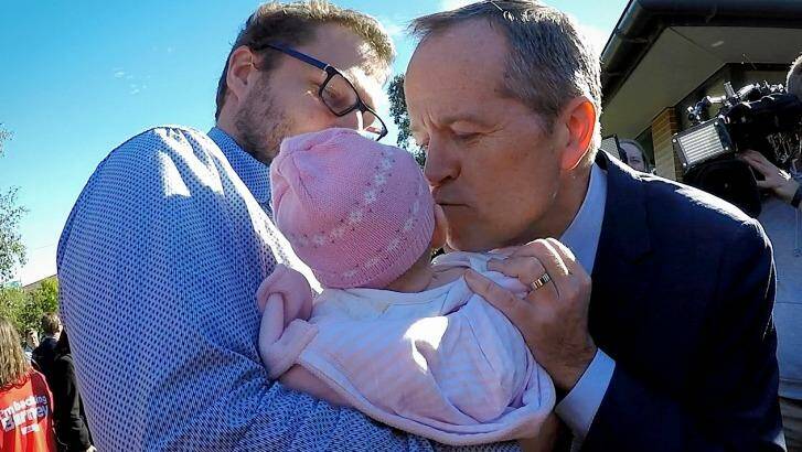 Opposition Leader Bill Shorten kisses a baby during the election campaign. Photo: Alex Ellinghausen
