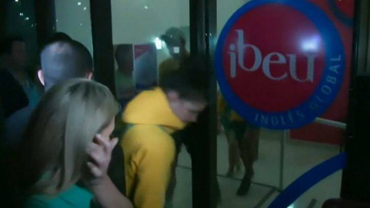 Some of the athletes who were detained by police for accreditation tampering leave a police station in Rio. Photo: Screengrab/ABC24