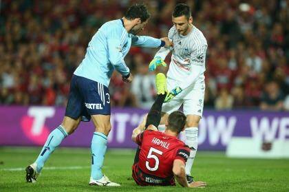 Helping hand: Vedran Janjetovic reaches out to Brendan Hamill during the Sydney derby. Photo: Getty Images 